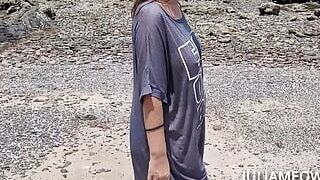 Hot mom in transparent t-shirt on the beach at low tide