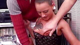 A tattooed German babe loves two hard cocks at the same time