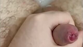 Chubby guy with tight foreskin wanks in the bath with cumshot