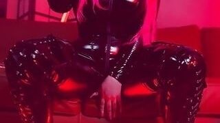 Pink haired Luvie Doll smoking her EVE 120s cigarette like a demon in her pvc catsuit and long fingernails
